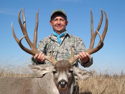 Rick Meritt of Gilmer, a previous Texas Big Game Awards honoree, poses with another of his trophy mule deer.